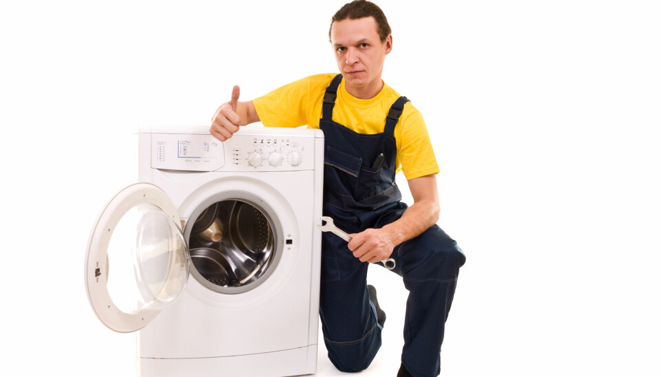 Repairman and washing machine isolated on white background