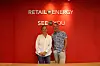 TAnn-Kristin Fiskebeck og Tom-Erik Andersen, stående foran en rød vegg med påskrift Retail Energy og  SeeYou.