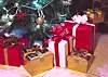 Presents boxes under the Christmas tree. Gold, red and white colours